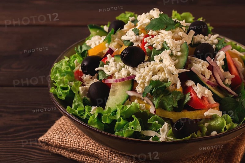 Traditional Bulgarian dish, Shopska salad, on a wooden table, salad of fresh vegetables, top view, close-up, no people, Bulgarian food, Bulgarian cuisine, salad, vegetables