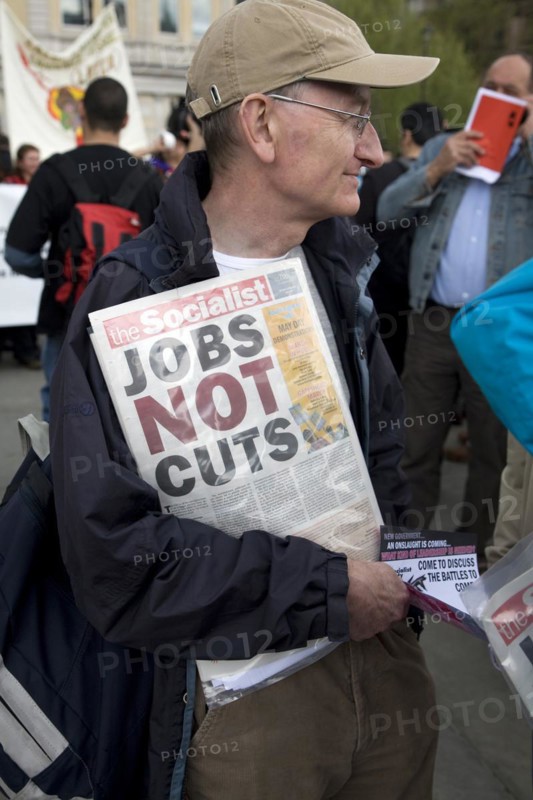 May Day march and rally at Trafalgar Square, London, England, UK May 1st, 2010 Man holding Socialist Party newspaper 'The Socialist'