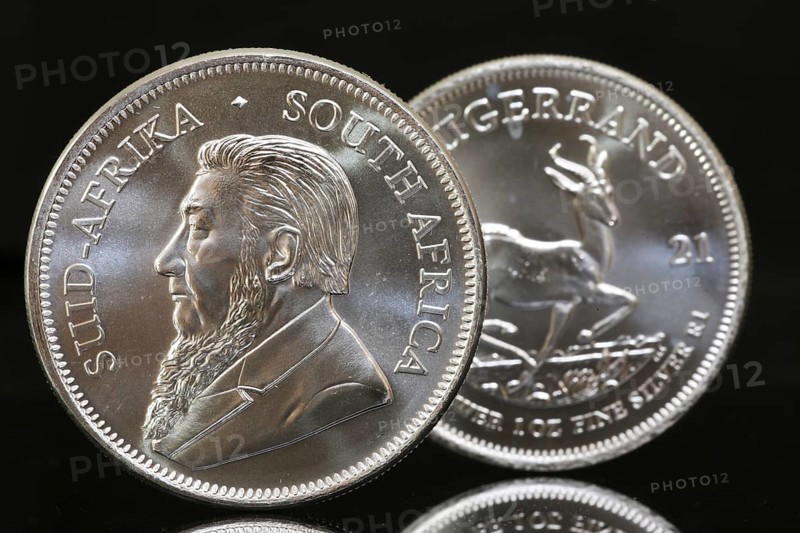 Close-up of two Krugerrand silver coins