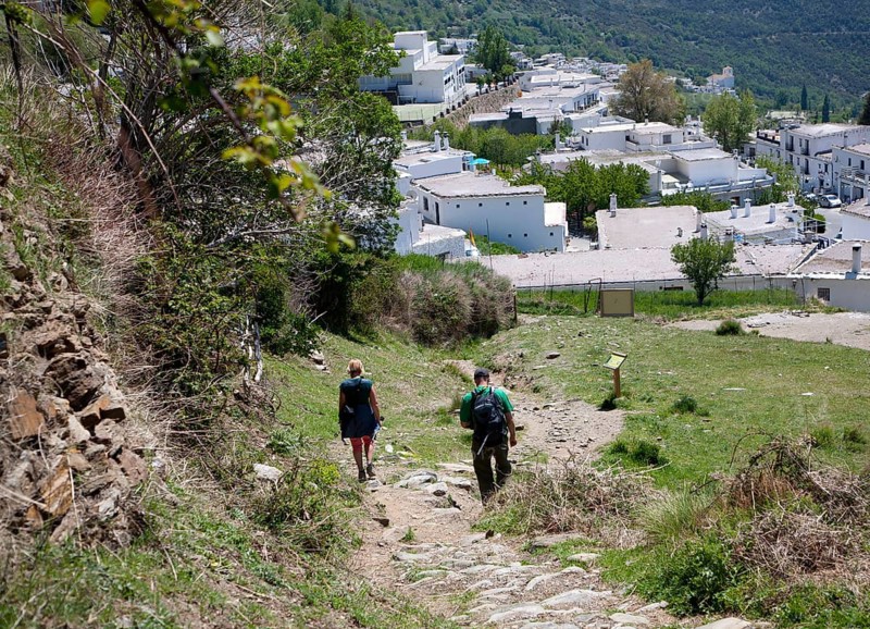 Walkers arriving at the village of Capileira, High Alpujarras, Sierra Nevada, Granada province, Spain, Europe