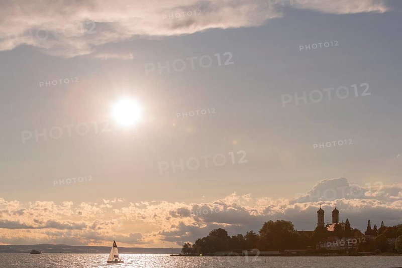 Baroque castle church, double tower, onion dome, evening light, sailing boat, Friedrichshafen on Lake Constance Baden-Württemberg, Germany, Europe