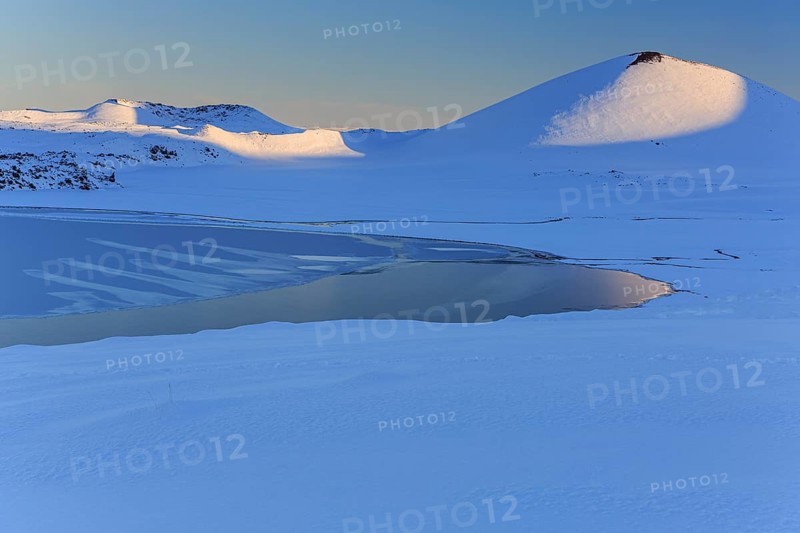Morning light on a snowy lava field, lake, volcanic crater, snow, winter, Berserkjahraun, Snaefellsnes, Vesturland, Iceland, Europe