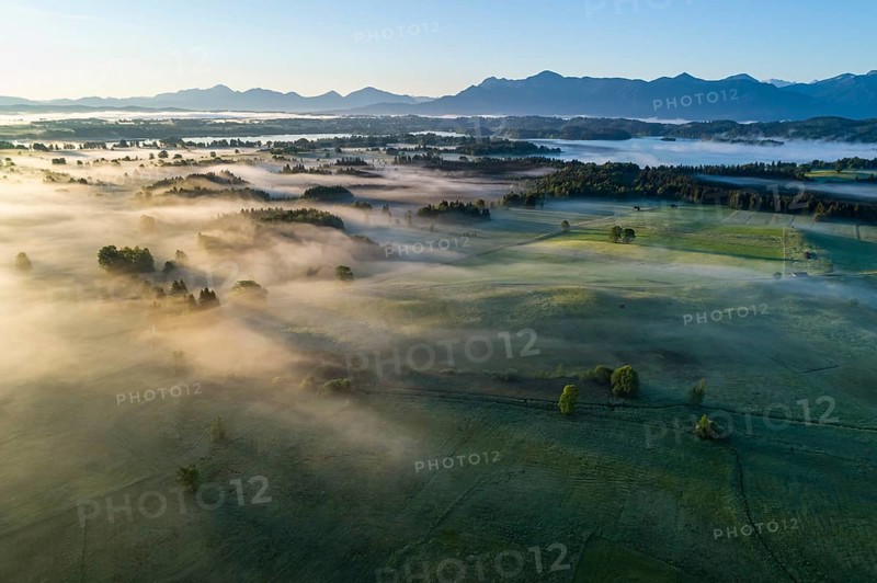 Aerial view of meadows and trees in front of mountains in backlight, sunrise, fog, autumn, Murnau, Alpine foothills, Upper Bavaria, Bavaria, Germany, Europe