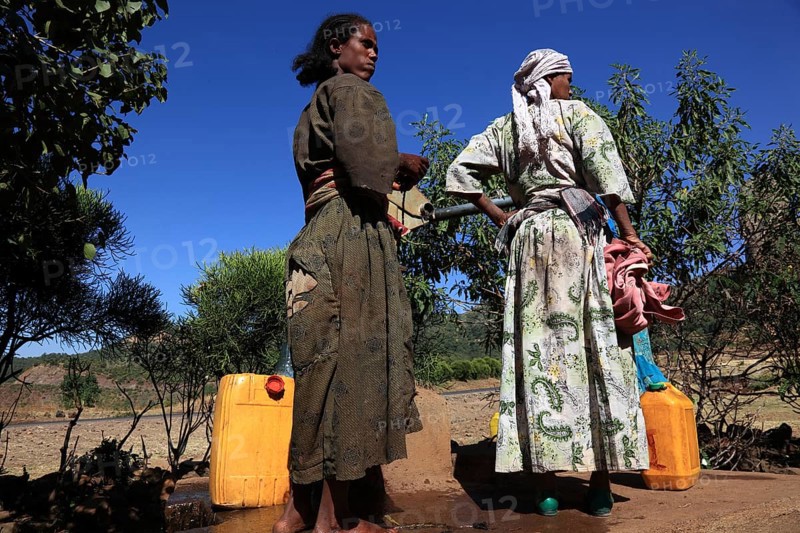 Amhara region, locals fetching water from a well, Ethiopia, Africa