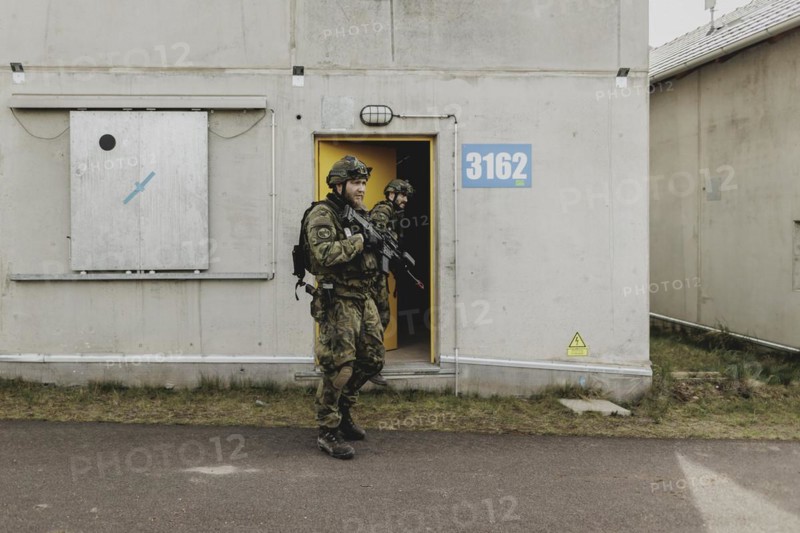 Two soldiers move during a simulated house-to-house battle, taken as part of a Bundeswehr exercise with armed forces from Norway and the Czech Republic during the 'Wettiner Schwert' exercise as part of Quadriga 2024 in the training town of Schnöggersburg, 8 April 2024