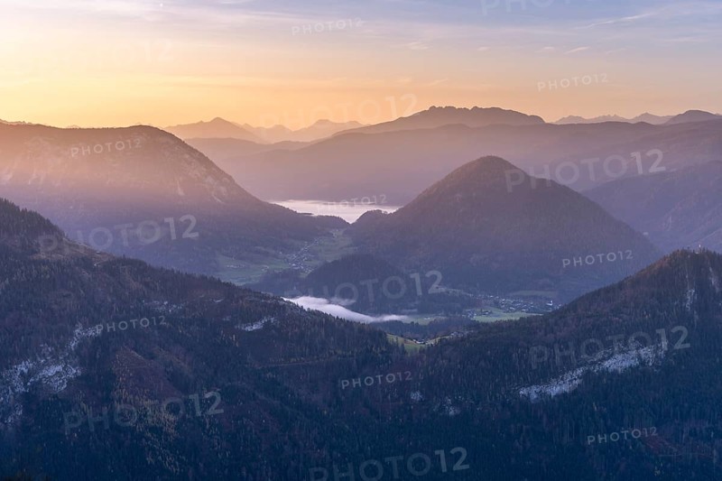 View from the Loser to the mountains and Grundlsee in the background. In the morning at sunrise. Blue sky. Autumn. Altaussee, Bad Aussee, Ausseer Land, Totes Gebirge, Styria, Upper Austria, Austria, Europe