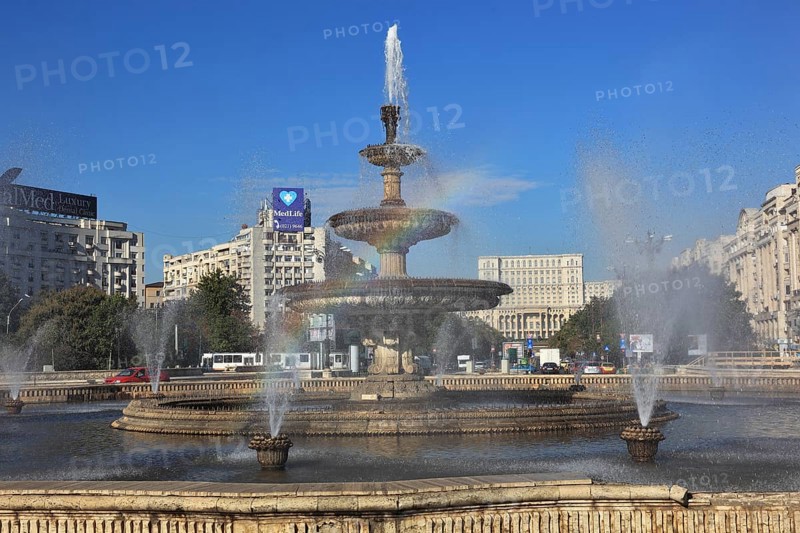 City centre, fountains and skyscrapers at Bulevardul Unirii, behind the Palace of Parliament, Bucharest, Romania, Europe