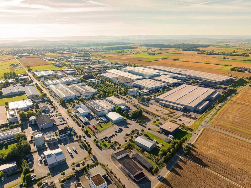A large industrial area with factories, roads and surrounding fields in a rural area, taken from a bird's eye view, Wolfsberg industrial area, Nagold, Black Forest, Germany, Europe