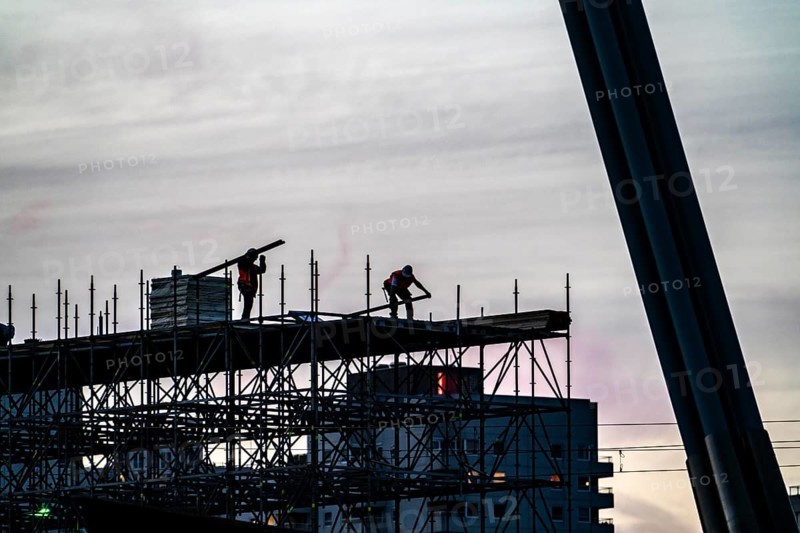 Workers dismantle scaffolding on the Erasmus Bridge over the Nieuwe Maas in Rotterdam, Netherlands