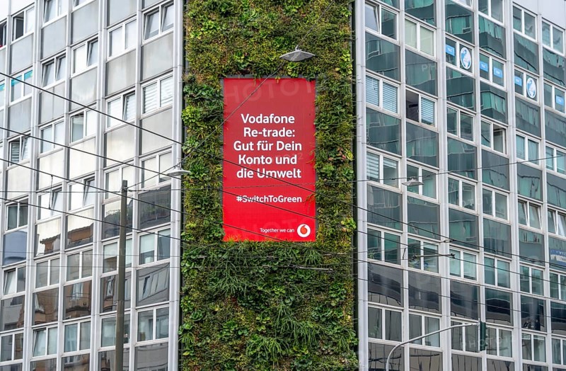 Green façade on a building, Areo Treibhaus office building, on Graf-Adolf-Straße in Düsseldorf, 100 square metre vertical garden, green climate-active façade, with digital advertising space, plants are artificially watered and supplied with nutrients, North Rhine-Westphalia, Germany, Europe