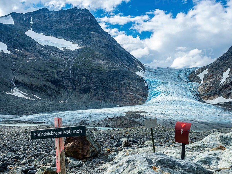 Glacier Steindalsbreen, glacier tongue, signpost and 'trimkassa' at end of valley Steindalen, Lyngen alps, south of Lyngseidet, Troms county, Norway, Europe