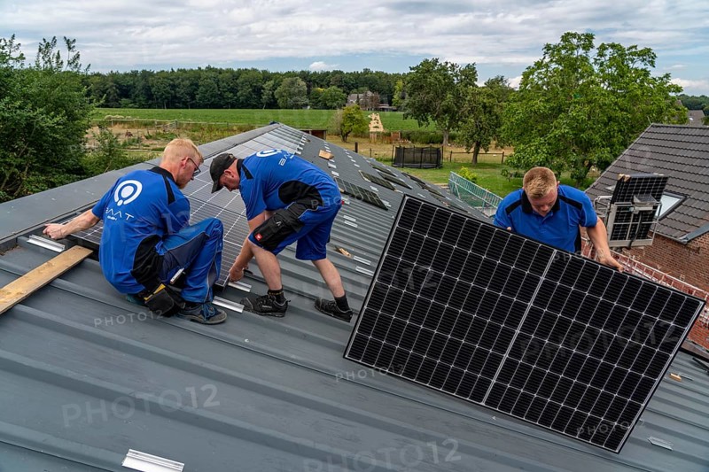 Installation of solar modules on the roof of a barn on a farm, over 240 photovoltaic modules are installed on the roof, North Rhine-Westphalia, Germany, Europe
