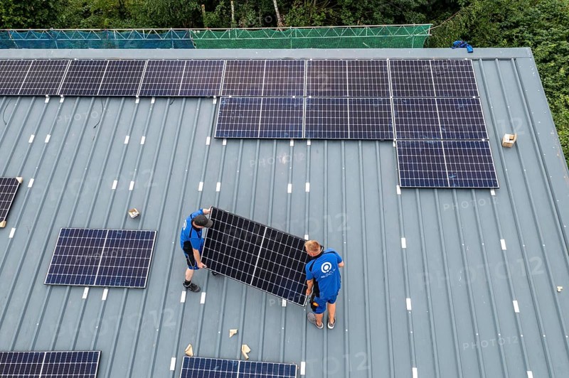 Installation of solar modules on the roof of a barn on a farm, over 240 photovoltaic modules are installed on the roof, North Rhine-Westphalia, Germany, Europe