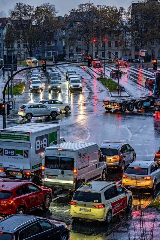 Rainy weather, road traffic, intersection, lights of vehicles on a wet road, traffic lights, tail lights, headlights, symbolic image