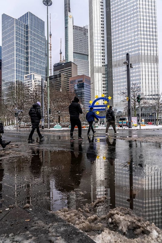Winter in the city, Gallusanlage street, puddles, pools of water, melt water, pedestrians, Frankfurt, Hesse, Germany, Europe