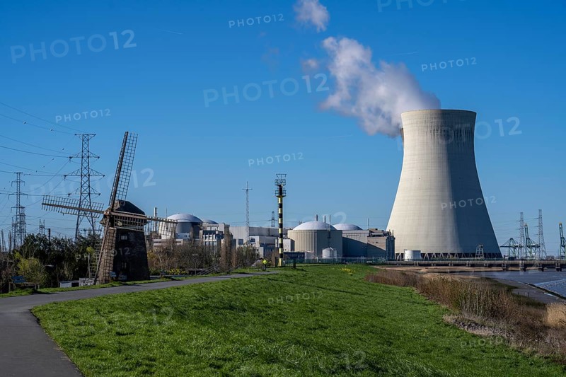 The Doel nuclear power plant on the Scheldt, one of two nuclear power plants in Belgium, consists of three operating units, each with a pressurised water reactor, as well as a decommissioned unit, historic Scheldemolen, windmill on the Scheldt dike, Antwerp, Belgium, Europe