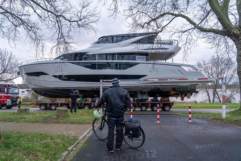 Craning the €6.3 million Sunseeker 88Y motor yacht, weighing 82 tonnes, in preparation for the world's largest water sports trade fair, Boot in Düsseldorf, luxury yachts are driven across the Rhine to the trade fair and brought ashore with the help of the Big Willi ship crane and transported to the exhibition halls on a low-loader, North Rhine-Westphalia, Germany, Europe