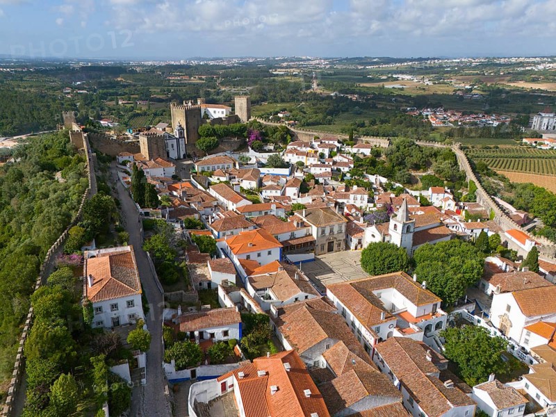 Aerial view of a historic town with red roofs, surrounded by castle walls, embedded in a green landscape, town, castle, Castelo de Óbidos, town wall, Óbidos, Obidos, Oeste, Centro, Estremadura, Portugal, Europe