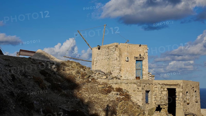 Abandoned mill ruins on a hill under a blue sky with clouds, historical, Colourful mountain village, Morning light, Olymbos, Karpathos, Dodecanese, Greek Islands, Greece, Europe
