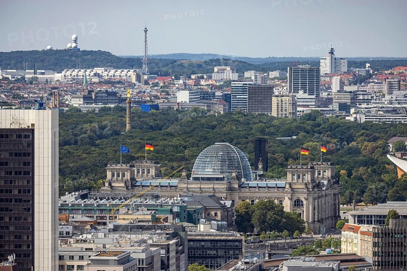View of Reichstag with German flag, radio tower and ICC trade fair centre. City view. Berlin, Germany, Europe