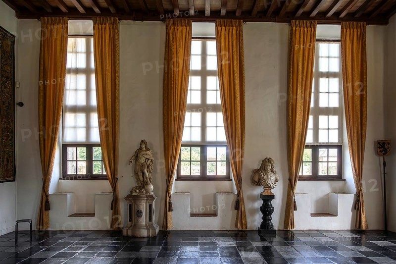 Kasteel van Laarne, interior showing busts and stone window seats of 14th century medieval moated castle near Ghent, East Flanders, Belgium, Europe