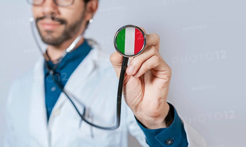 Doctor holding stethoscope with Italy flag. Italian Health and Care Concept, Italy flag on stethoscope