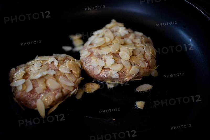 Swabian cuisine, meatballs wrapped in almonds, mixed minced meat, raw, frying meatballs in fat, frying pan, meatballs, grandmother's cooking, regional, home cooking, typical Swabian, traditional cuisine reinterpreted, food photography, studio, Germany, Europe