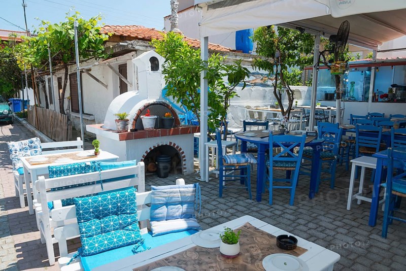 Cosy restaurant with blue and white outdoor furniture, surrounded by plants, invites you to linger, Sarti, Sithonia, Chalkidiki, Halkidiki, Central Macedonia, Greece, Europe