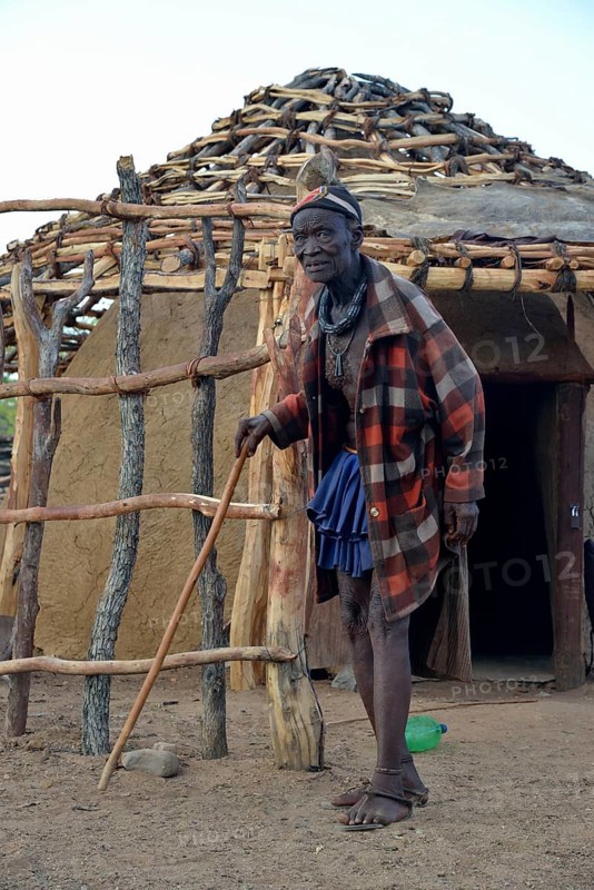Chief Hikuminue Kapika, chief of the Namibian Himba in front of his hut, Omuramba, Kaokoland, Kunene, Namibia, Africa