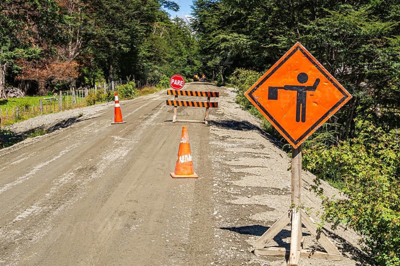 Construction work on the Carretera Austral road, stop sign, gravel road, forest north of Caleta Tortel, Patagonia, Chile, South America