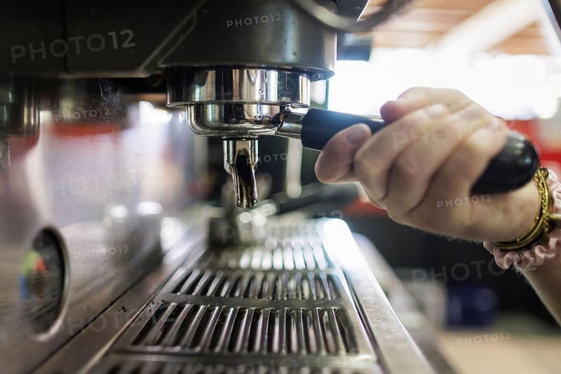 Symbol photo on the subject of a sieve coffee machine. A woman makes a coffee at a coffee machine in a cafe in Berlin, 14/08/2024