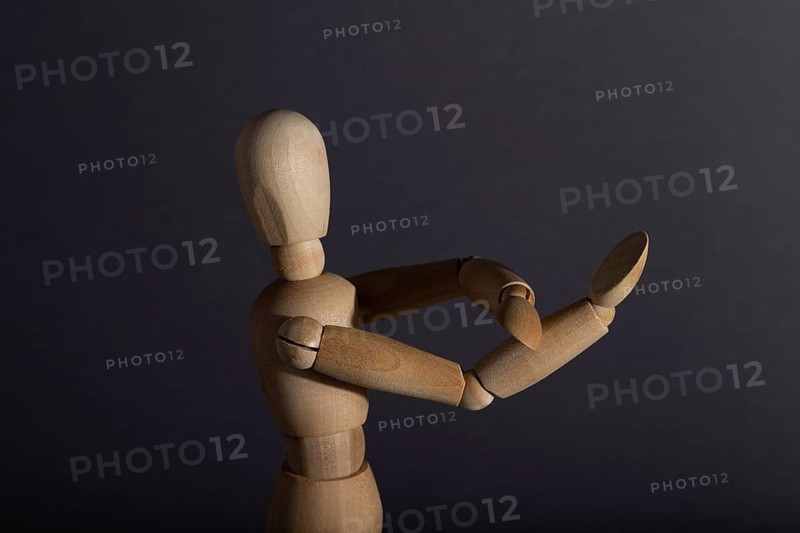 Wooden mannequin shows obscene gesture fuck off with hands on gray background. protest, riot, agression, contempt concept. copy space, hard light