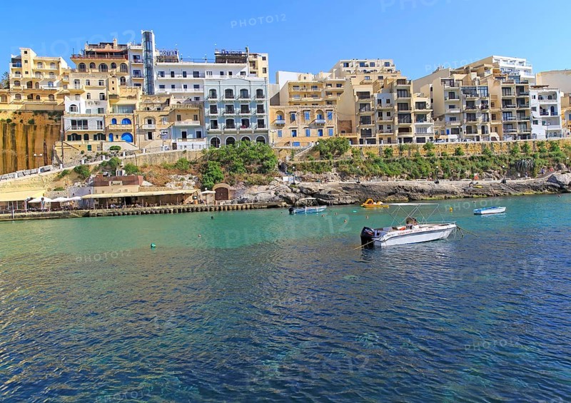 Waterfront hotel buildings beach and sea at Xlendi, island of Gozo, Malta, Europe
