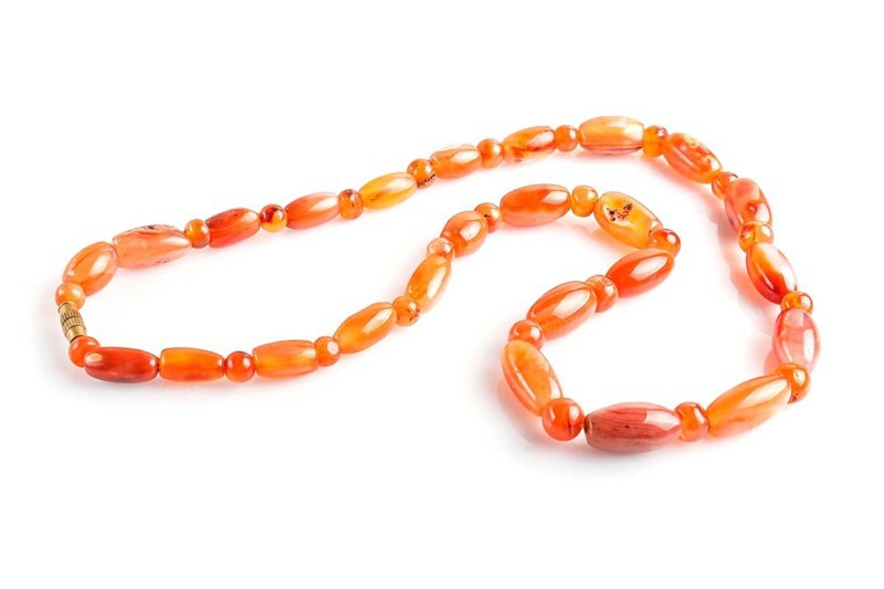 Colored onyx beads isolated on white background. top view, close up