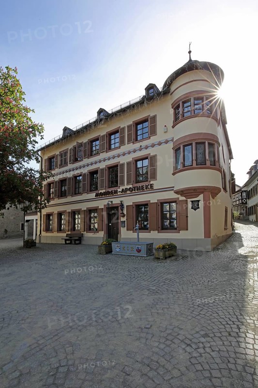 Historic Mohren Pharmacy built 17th century in backlight, building with corner turrets, turrets, oriel, market square, Meisenheim, Rhineland-Palatinate, Germany, Europe