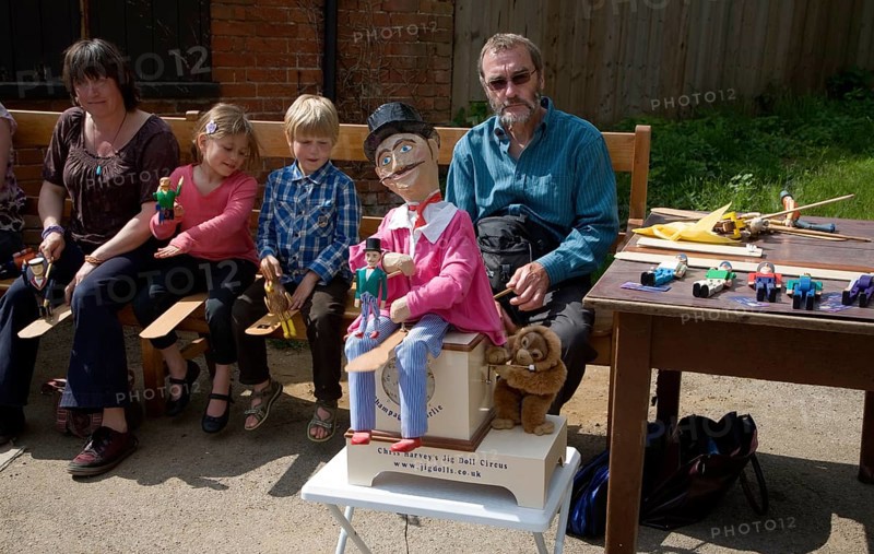 Man operating a traditional wooden jig doll dancer during a country folk event at Shottisham, Suffolk, England, United Kingdom, Europe