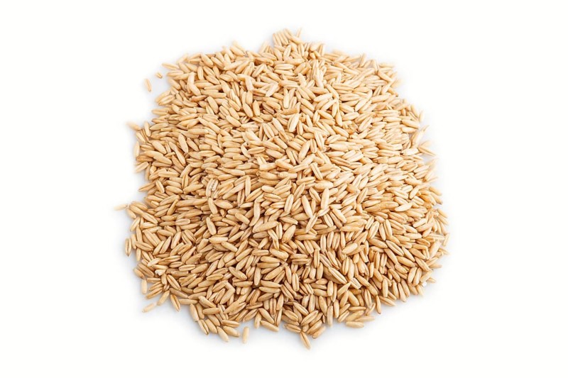 Heap of oats grains isolated on white background. close up, top view