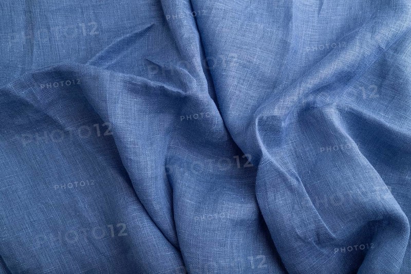 Fragment of blue linen tissue. Top view, natural textile background and texture. wave concept, abstract