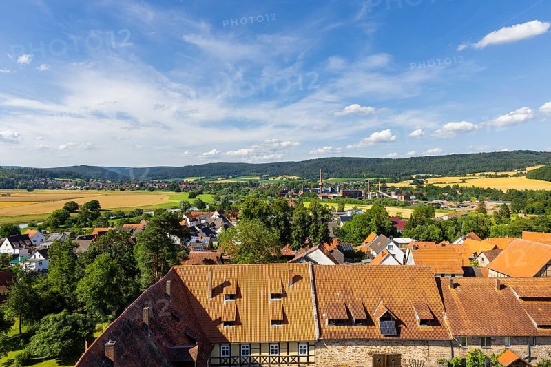 The Lippoldsberg Convent with the Church of St George and St Mary is a former Benedictine convent, which was the origin of the village of Lippoldsberg on the Weser in northern Hesse. In the background, the technical facilities of ProFagus GmbH for beech barbecue charcoal production in the district of Lippoldsberg in Bodenfelde, Lippoldsberg, Lippoldsberg, Hesse, Germany, Europe
