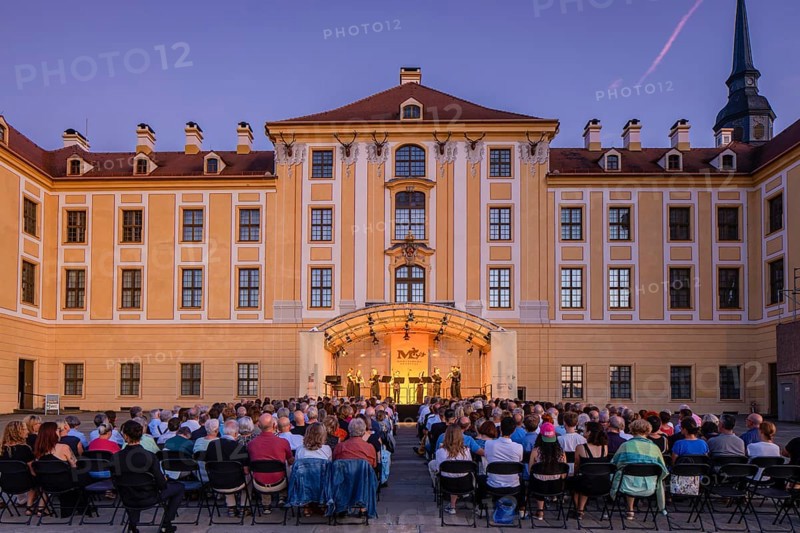 The Moritzburg Festival is an annual chamber music event in Saxony. It was founded in 1993 in Moritzburg by the soloists Kai Vogler, Peter Bruns and Jan Vogler. In Moritzburg, the artists find the ideal setting for the realisation of their musical dreams. The Moritzburg Festival, which has been under the sole artistic direction of cellist Jan Vogler since 2001, has long since established itself internationally as one of the most important festivals for chamber music thanks to its exceptional quality. Here is an evening concert on the north terrace of the baroque palace, Moritzburg Chamber Music Festival, Moritzburg, Saxony, Germany, Europe