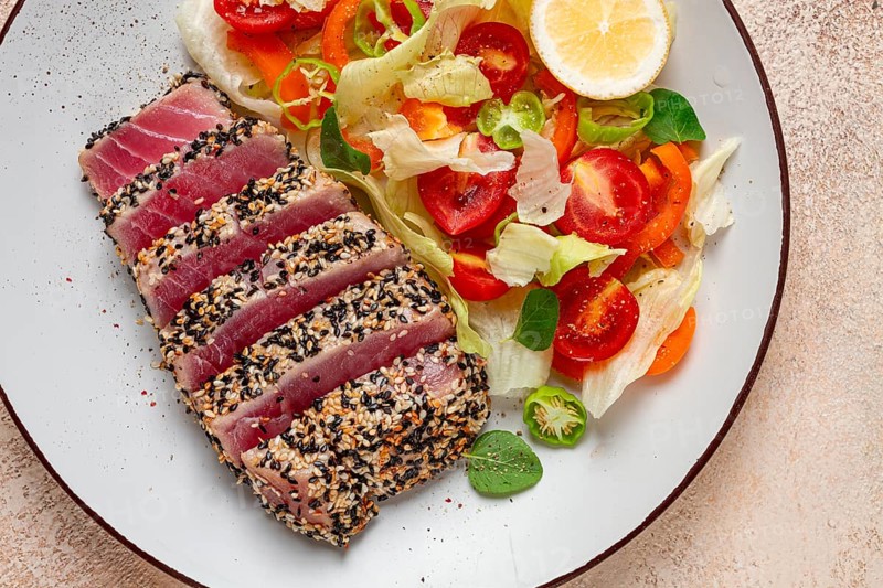 Fillet of red tuna meat, fried in sesame seeds, homemade, close-up, no people, on a wooden background