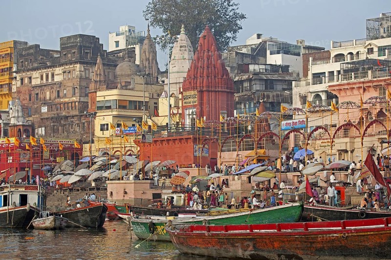 Holy city and colourful rowing boats on the Ganges river at Varanasi, Uttar Pradesh, India, Asia