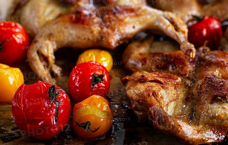 Grilled quail meat, on a platter, tobacco, in the oven, with spices, homemade, without people