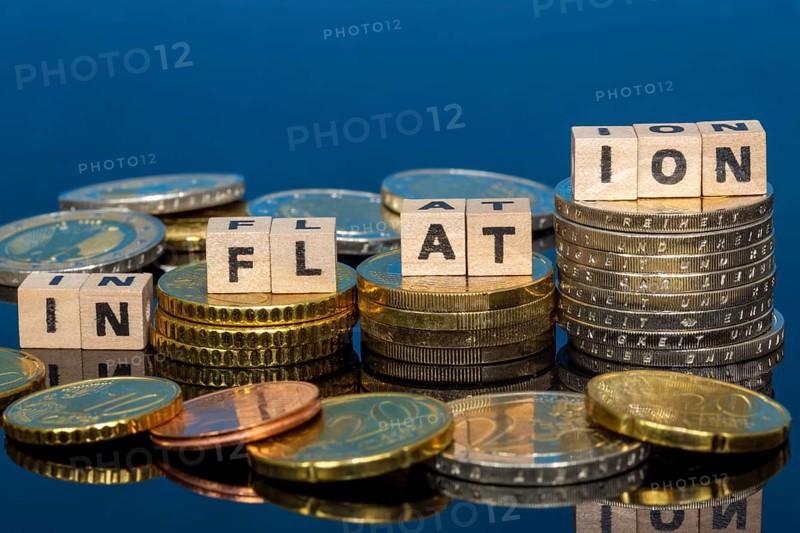 Symbolic image of inflation: euro coins and letters displaying the word INFLATION