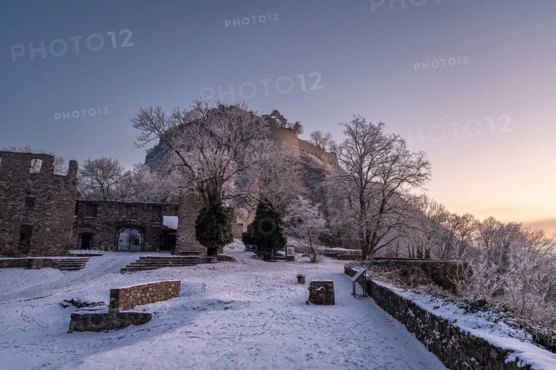 The snow-covered Karlsbastion of the Hohentwiel fortress ruins in front of sunrise on a cold winter morning, Singen am Hohentwiel, Constance district, Baden-Württemberg, Germany, Europe
