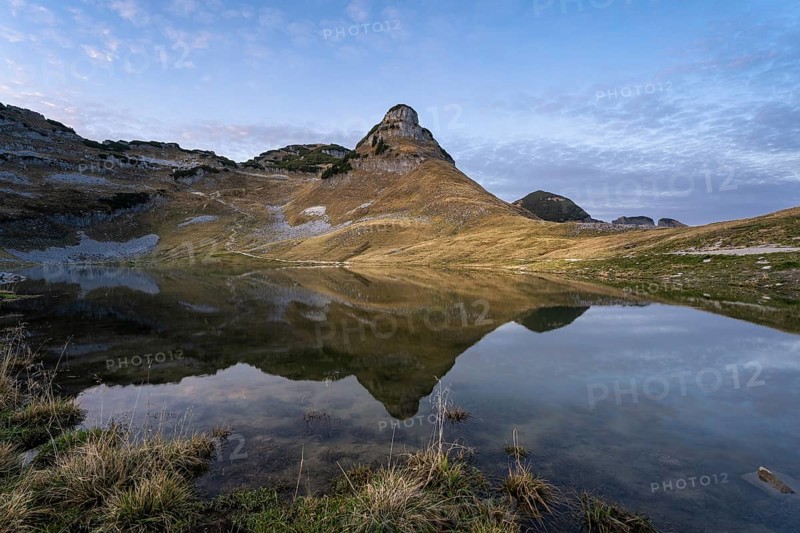 Lake Augstsee and the Atterkogel mountain on the Loser. Autumn, good weather, blue sky. In the evening after sunset. Reflection Altaussee, Bad Aussee, Ausseer Land, Totes Gebirge, Styria, Upper Austria, Austria, Europe