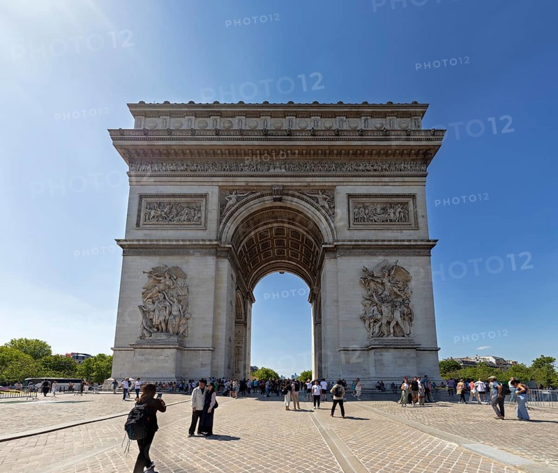 Front view of the Arc de Triomphe, people walking under the sunny sky, Paris