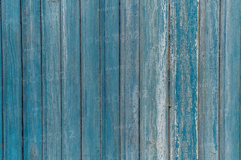 Garage door boards stained blue with worn paint. Brittany France