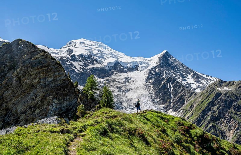 Mountaineer on a hiking trail in front of mountain landscape with glacier, view of glacier Glacier de Taconnaz, hike La Jonction, Chamonix, Haute-Savoie, France, Europe