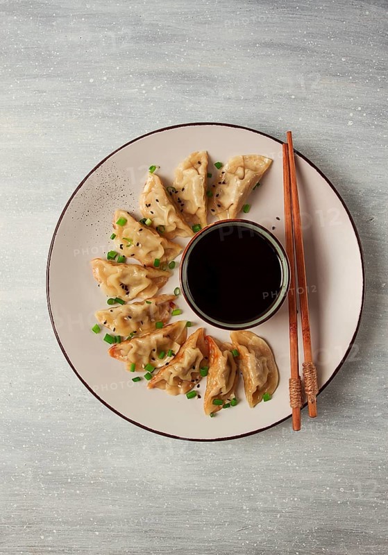 Japanese Gyoza dumplings, fried, with sauce, top view, without people, tinted, selective focus